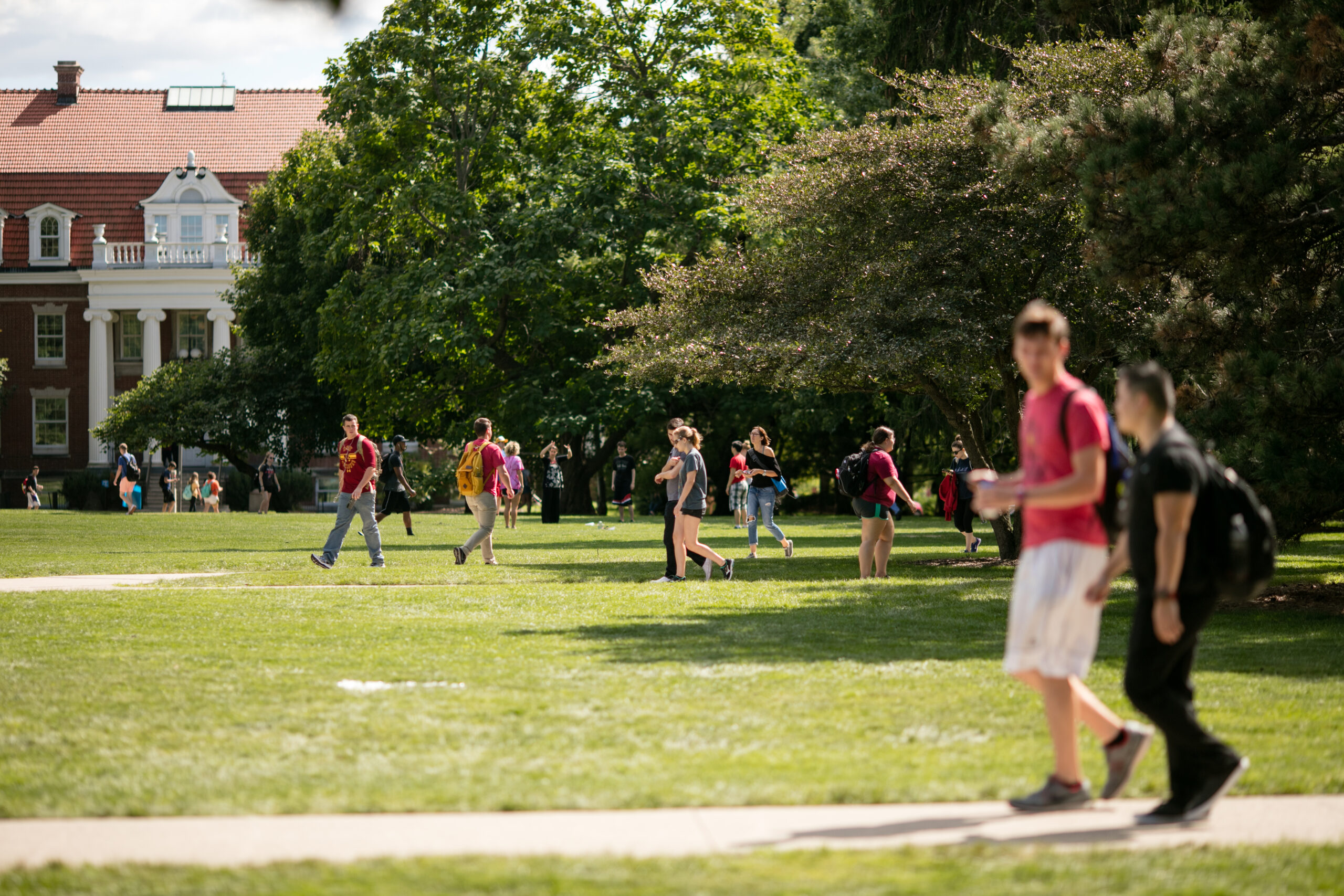 Photo of students walking across Iowa State's campus.